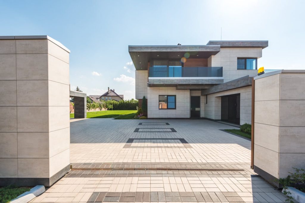 pexels-photo-8134821 Contemporary two-story luxury home with spacious paved driveway and garden.